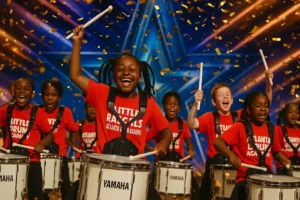 Here are a few options for alt text for the featured image, keeping Google Discover guidelines and accessibility in mind: Alt Text Options: "The Atlanta Drum Academy's 'Little Rascals' youth drumline beaming with joy on the America's Got Talent stage, covered in golden confetti after receiving the golden buzzer.